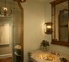 A custom vanity with a gold leaf and glass sink bring elegance and charm to a Powder Room.